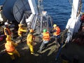 The Sea of Okhotsk / Russia - July 10 2015: Science expedition team on the stern of RV Akademik Lavrentyev preparing the multicore