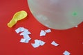 Science experiment about static electricity from balloon and pieces of paper.