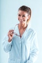 Science expert woman, holds glasses, smiling gently