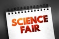 Science fair - competitive event, hosted by schools worldwide, text on notepad concept for presentations and reports Royalty Free Stock Photo