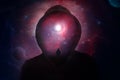 A science fiction concept of a hooded figure without a face. Over layered with a man looking into a universe of stars and planets Royalty Free Stock Photo