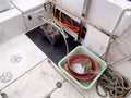 The science equipment: benthic grab sampler, square basin and sieve on the boat