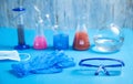 Science glassware with colored liquid gloves and glasses Royalty Free Stock Photo