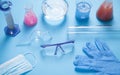 Science glassware with colored liquid, gloves and glasses Royalty Free Stock Photo