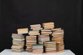 science knowledge reading many books in stacks in the library on a black background Royalty Free Stock Photo