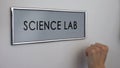 Science lab door, hand knocking close up, chemical experiments, biology research