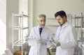 Science lab supervisor and assistant discussing experiment results together Royalty Free Stock Photo