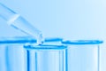 Science laboratory test blue tubes, macro flask equipment. Chemical dropper