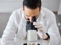 Science, microscope and a doctor man at work in a laboratory for innovation or research. Medical, analytics and Royalty Free Stock Photo