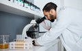 Science, microscope and innovation with a doctor man at work in a laboratory for research or development. Medical Royalty Free Stock Photo