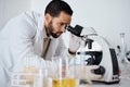 Science, microscope and research with a doctor man at work in a laboratory for innovation or development. Medical Royalty Free Stock Photo