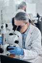 Science, research and microscope with woman in laboratory working on medical, vaccine and pharmacy development