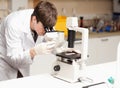 Science student looking in a microscope Royalty Free Stock Photo