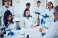Science, students and education in a medical laboratory writing notes during scientist lecture or lesson with mentor or