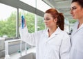 Science students looking at a graduated cylinder Royalty Free Stock Photo