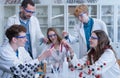 Science students with teacher doing chemical reaction experiment in the laboratory at university. Low angle view. Royalty Free Stock Photo