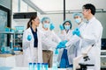 A science team joining hands in a modern laboratory, showing unity, motivation, teamwork, and collaboration while working together Royalty Free Stock Photo