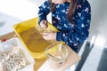 Science workshops for children. A little girl preparing a model of the air molecule from beans, peas and sand