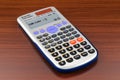 Scientific calculator on the wooden table. 3D rendering