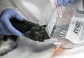 Scientific police officer examining traces of a gun in ballistic laboratory