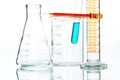 Scientific research glassware pipette drop, reflective white bac Royalty Free Stock Photo