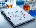 Scientific Research Notebook with Molecular Structure Diagrams and Laboratory Glassware Royalty Free Stock Photo