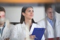 Scientific researcher holding a folder of chemical experiment research.Science students working with chemicals in the lab at the u Royalty Free Stock Photo