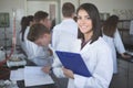Scientific researcher holding a folder of chemical experiment research. Science students working with chemicals in the lab at the Royalty Free Stock Photo