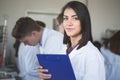 Scientific researcher holding a folder of chemical experiment research. Science students working with chemicals in the lab at the Royalty Free Stock Photo