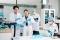 A scientific team working together in a modern laboratory, testing samples, mixing liquids, analyzing data, and using advanced lab Royalty Free Stock Photo
