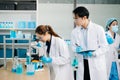 A scientific team working together in a modern laboratory, testing samples, mixing liquids, analyzing data, and using advanced lab Royalty Free Stock Photo