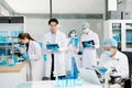 A scientific team working together in a modern laboratory, testing samples, mixing liquids, analyzing data, and using advanced lab Royalty Free Stock Photo