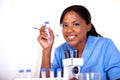 Scientific woman looking at you holding test tube