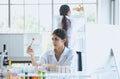 Scientist beautiful asian woman working with biopsy sample in laboratory