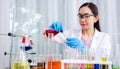 Scientist beautiful woman research and drop medical chemicals sample in test tube at laboratory, Science, chemistry, technology, Royalty Free Stock Photo