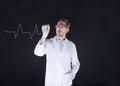 Scientist on a black background draws the ECG Royalty Free Stock Photo