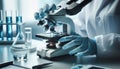 A scientist in blue gloves adjusts a microscope in a lab setting with blue liquid vials and scientific Royalty Free Stock Photo