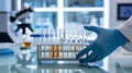 Scientist in blue gloves handling test tubes in a laboratory Royalty Free Stock Photo