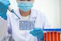 Scientist with cell culture in sample micro plate for research in science laboratory Royalty Free Stock Photo