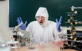 A scientist in a chemical laboratory is disappointed by a failed experiment with chemicals