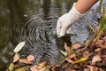 A scientist collects river water in a glass beaker