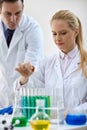 Scientist combining the chemical liquid using a pipette in test