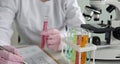 Scientist conducting experiments with test tubes and microscope in a laboratory Royalty Free Stock Photo