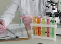 Scientist conducting research with test tubes and microscope in laboratory Royalty Free Stock Photo