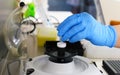 Scientist conducts experiment using centrifuge in laboratory setting for research analysis and sample processing Royalty Free Stock Photo