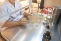Scientist cutting plant tissue culture in petri dish, small plant testing, asparagus and other tropical plant. Thailand