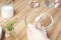 Scientist developing cosmetic product at table in laboratory, closeup