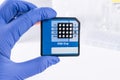 Scientist with DNA Sequencing Chip. Medical laboratory.