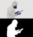 Scientist or docrot wearing biohazard suits and protective masks using digital tablet while walking, Alpha Channel