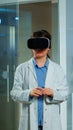 Scientist doctor in sport science laboratory wearing virtual reality goggles